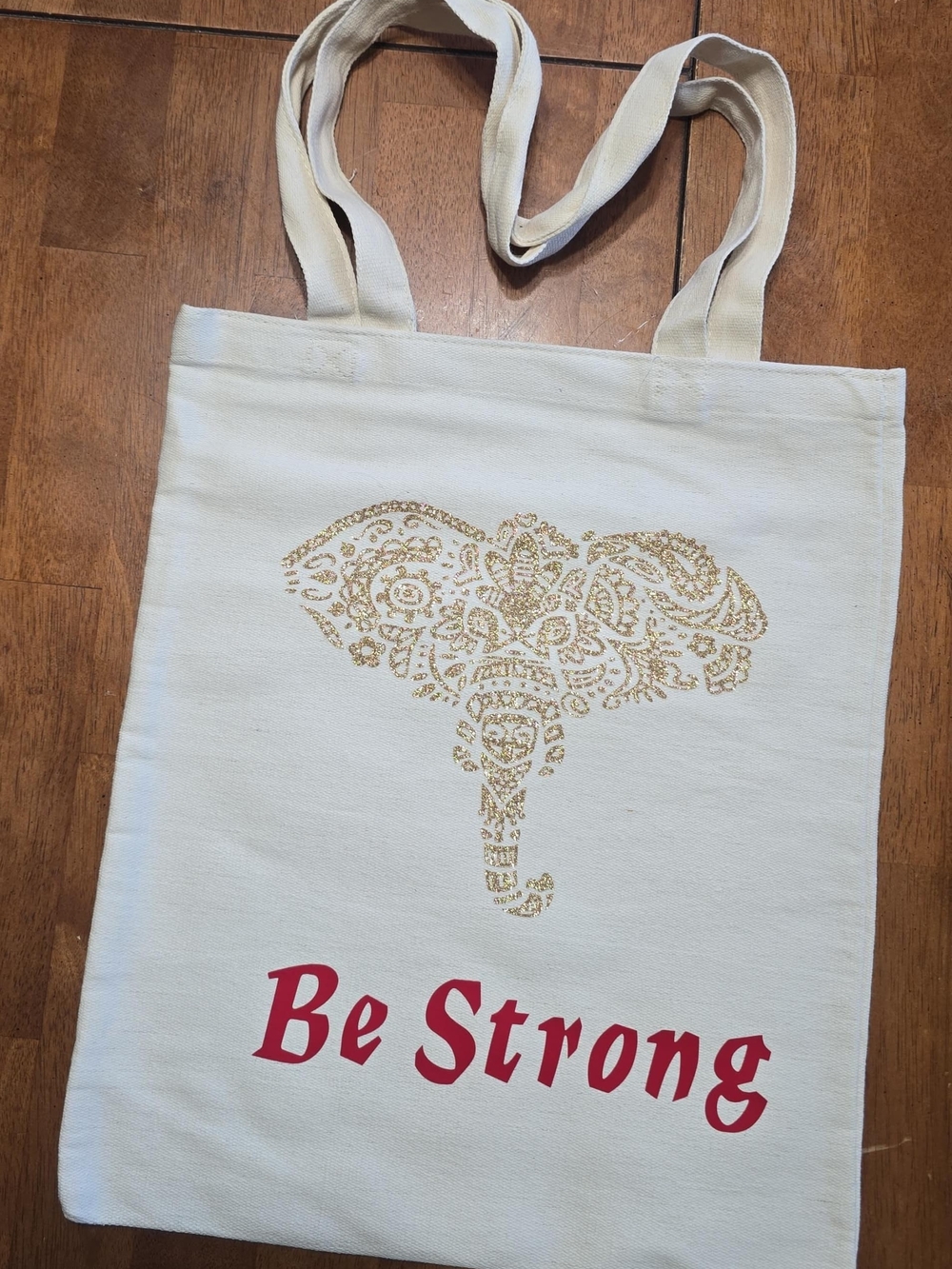 Cream Heavy Canvas Tote Bag with Gold Elephant Design and Red "Be Strong" Print